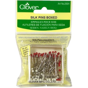 May include: A box of 100 red and white headed silk pins, packaged in a clear plastic bag. The box is labeled "Silk Pins Boxed" and "Clover Mfg. Co., Ltd. Japan".