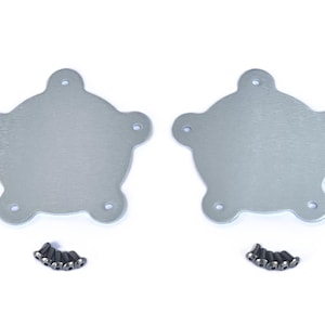 May include: Two silver-colored, star-shaped metal plates with five screw holes each, accompanied by small black screws. The plates have a rounded design with protruding edges. The items are displayed on a white background.