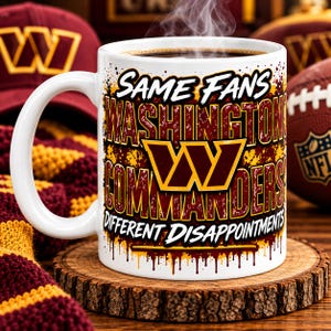 May include: A white ceramic mug featuring the text SAME FANS WASHINGTON COMMANDERS DIFFERENT DISAPPOINTMENTS in burgundy and gold lettering with a distressed paint drip effect and the Washington Commanders logo in the centre.