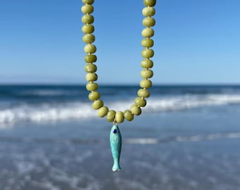 green jade gemstone necklace with turquoise enamel fish charm, colorful beach charm necklace