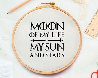 May include: A white embroidery hoop with a black embroidered quote that reads "Moon of my life, my sun and stars".