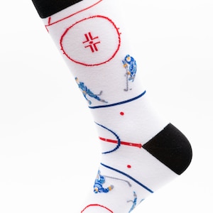 May include: White socks with a hockey rink design. The socks feature red and blue hockey players and a red center circle with a black cross.