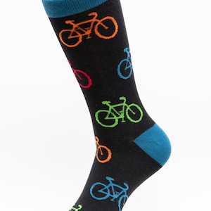 May include: Black sock with a blue cuff and toe, decorated with bicycles in orange, green, red, and blue. The sock is shown against a white backdrop.