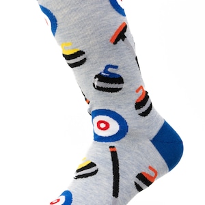 May include: A pair of gray socks with a blue cuff and a pattern of curling stones, brooms, and targets.