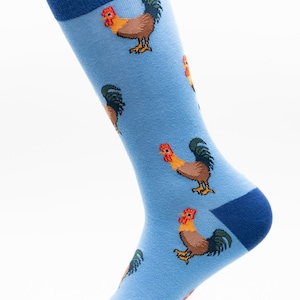 May include: A pair of blue socks with a rooster pattern. The socks are made of a soft, comfortable material and have a blue cuff.