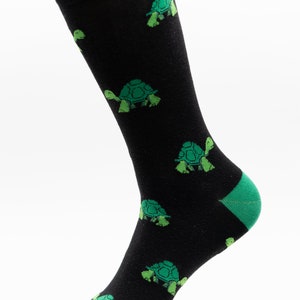 May include: Black socks with a green turtle pattern.