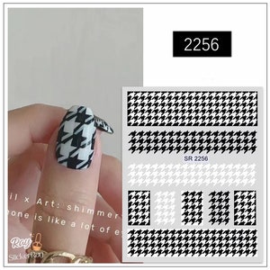 May include: Black and white houndstooth nail art stickers. The stickers are in a variety of sizes and shapes, and they are perfect for adding a touch of style to your nails. The stickers are easy to apply and remove, and they are long-lasting. SR 2256.