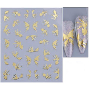 May include: Gold nail art stickers featuring various aquatic and butterfly designs. The stickers include fish and butterfly shapes, perfect for nail art. The image also shows examples of the stickers applied to nails, showcasing the designs.