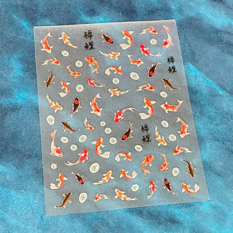 May include: Clear sheet with a pattern of koi fish in shades of red, orange, black, and white. The fish are swimming in various directions, with bubbles and Japanese characters scattered throughout the design.