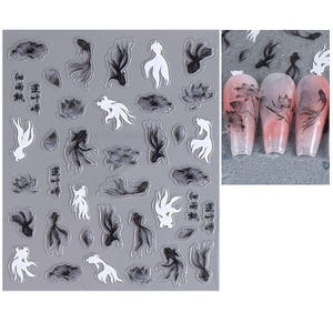 May include: Nail art stickers featuring black and white koi fish, lotus flowers, and abstract shapes. The stickers are on a gray background, with examples of the designs applied to acrylic nails. The nail art designs include Chinese characters.