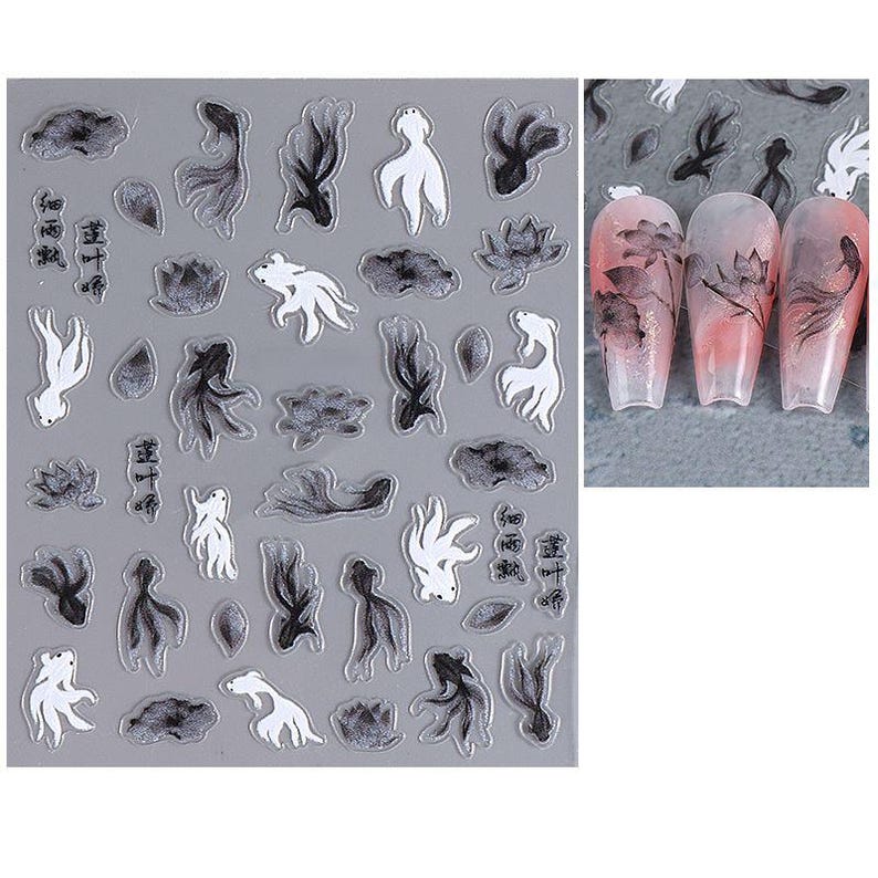 May include: Nail art stickers featuring black and white koi fish, lotus flowers, and abstract shapes. The stickers are on a gray background, with examples of the designs applied to acrylic nails. The nail art designs include Chinese characters.