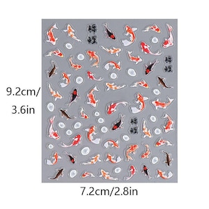 May include: A sheet of stickers featuring koi fish in various colors, including red, orange, black, and white. The stickers are arranged on a gray background, with a few Japanese characters. The sheet measures 3.6 inches by 2.8 inches.