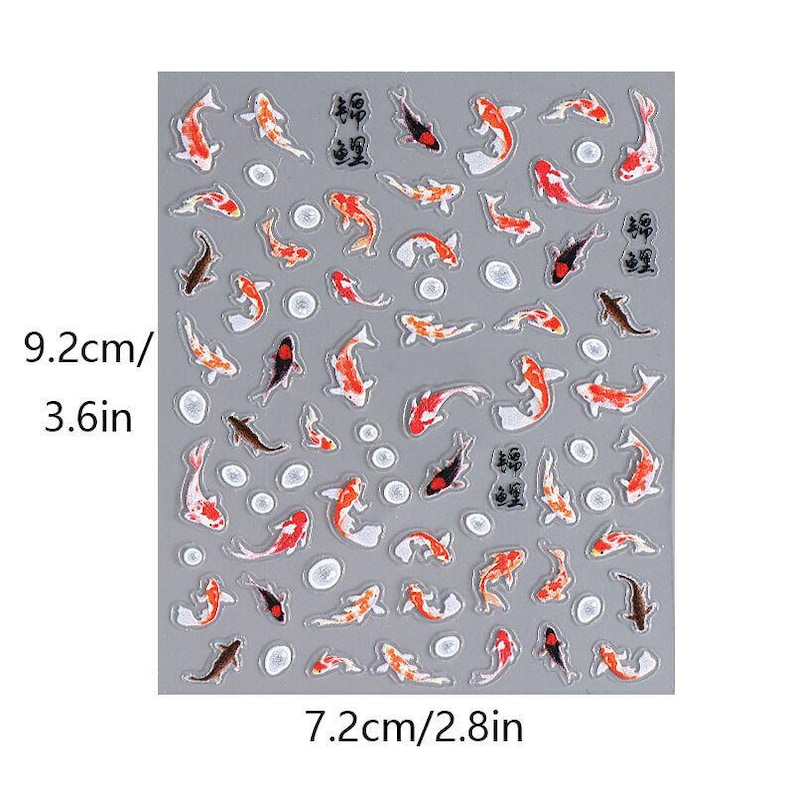 May include: A sheet of stickers featuring koi fish in various colors, including red, orange, black, and white. The stickers are arranged on a gray background, with a few Japanese characters. The sheet measures 3.6 inches by 2.8 inches.
