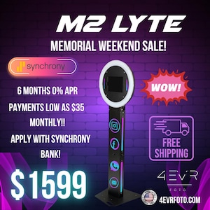 May include: The M2 LYTE photo booth features a circular ring light surrounding a central screen, mounted on a tall black vertical stand. The stand displays social media icons and includes text such as MEMORIAL WEEKEND SALE, 6 MONTHS 0% APR, and $1599.