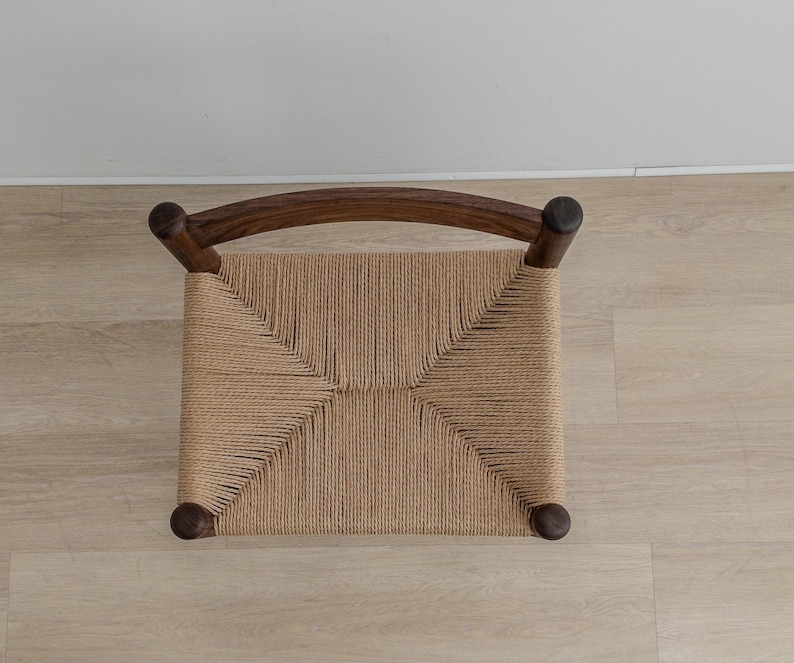 May include: A wooden chair with a woven cane seat. The chair has a dark brown finish and a simple design.