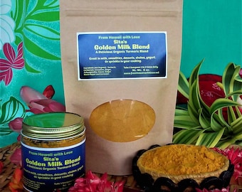 May include: Two brown paper bags with a golden turmeric blend powder inside. The bags are labeled "Sita's Golden Milk Blend" and "From Hawaii with Love". The bags are sitting on a woven mat with red and green flowers.