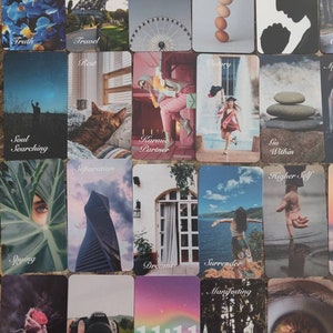 May include: A selection of tarot cards with diverse imagery and text. The cards display illustrations of a Ferris wheel, the Eiffel Tower, a cat, a woman, and other symbolic images. Text includes words such as "Truth", "Travel", "Cycles", and "11:11".