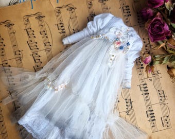 A long white dress with tulle and decorative trim for Blythe dolls.