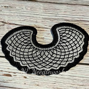 May include: Black and white embroidered fabric collar with a scalloped edge.