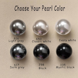 May include: Six spherical pearls arranged in two rows with the text Choose Your Pearl Color. The colors are labeled as 616 Light grey, 650 Classic white, Ivory white, 617 Dark grey, 298 Black, and 335 Mystic black with their respective numbers.