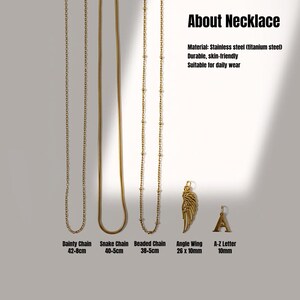 May include: A selection of gold-coloured necklaces, including a dainty chain, snake chain, and beaded chain. The image also features an angle wing pendant and an A-Z letter pendant. The necklaces are made of stainless steel.