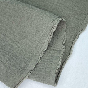 May include: A piece of soft, green fabric with a raw edge. The fabric has a slightly textured surface.