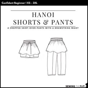 May include: A black and white line drawing of the Hanoi Shorts & Pants pattern. The text reads Confident Beginner | XS - 3XL, HANOI SHORTS & PANTS, A CROPPED SKIRT-OVER-PANTS WITH A DRAWSTRING WAIST, and SEWING THERAPY. It shows shorts and pants.