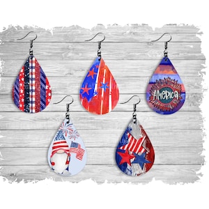 May include: Five pairs of dangle earrings with a patriotic theme. The earrings are red, white, and blue with stars, stripes, and a gnome holding a flag.