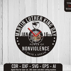 May include: Black and white clock design with a clock face featuring a stylized clock mechanism. The clock face is surrounded by the text "Martin Luther King Day" and "Jan 16th". The text "Power of Nonviolence" and "I Have a Dream" are also included in the design.
