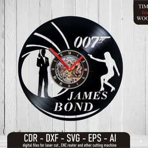 Puede incluir: Reloj de vinilo negro con una silueta blanca de James Bond y una mujer sosteniendo una pistola. La esfera del reloj tiene números romanos y un mecanismo de reloj. El texto "007" y "JAMES BOND" está impreso en el reloj.