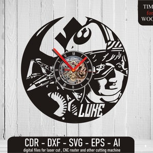 May include: Black laser-cut wooden wall clock featuring a detailed design of a character's face, a spaceship, and the text "LUKE". The clock has a visible mechanical movement with red hands and the text "TIME for WOOD". Includes digital files for laser cutting.