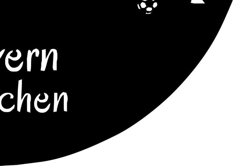 May include: Black and white sign with the text "Tavern" and "Kitchen" in a cursive font. A soccer ball is in the upper right corner of the sign.