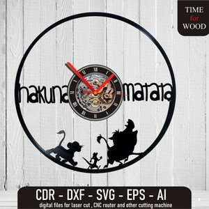 May include: Black vinyl record clock with a clock face featuring Roman numerals and a gear-like design. The clock is surrounded by a black circle with the words "hakuna matata" written in a stylized font. The clock is surrounded by silhouettes of characters from the movie The Lion King, including Simba, Pumbaa, and Timon.