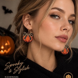 May include: Beaded pumpkin earrings featuring orange and black glass beads with a black bow detail. The earrings are suspended from gold-toned hooks. Text on the image includes HALLOWEEN EARRINGS, Spooky & Stylish, HANDMADE BEADED JEWELRY, BeadPatternNK, and PERFECT FOR HALLOWEEN SEASON.