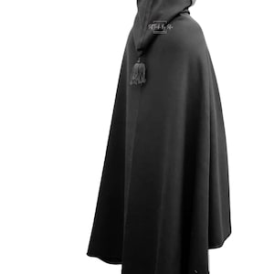 May include: A black hooded cloak with a tassel hanging from the hood.