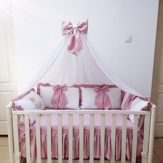 white and pink crib