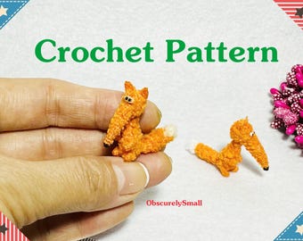 May include: Crochet pattern for a small orange fox amigurumi. The pattern is available for purchase on Etsy. The image shows two finished foxes, one held in a hand and the other lying on a white surface.