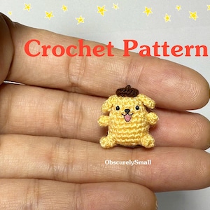 May include: A small, yellow crochet dog with a brown hat and a smiling face. The text "Crochet Pattern" is displayed in red, and the text "ObscurelySmall" is displayed in white. The background has yellow stars.