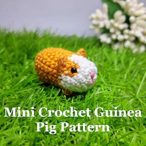 May include: A small crocheted guinea pig toy in orange and white, sitting on green grass. The toy has black eyes and a pink nose. The text "Mini Crochet Guinea Pig Pattern" is written below the toy.