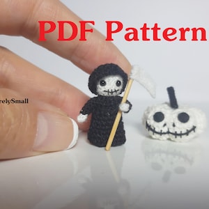 May include: A miniature crochet Grim Reaper doll with a scythe and a white pumpkin with a carved face. The doll is black and white, and the pumpkin is white with black details. The text "PDF Pattern" is in red.