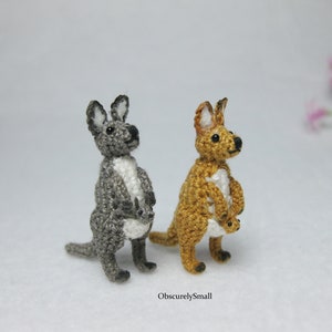May include: Two crocheted kangaroo toys, one gray and one brown, both holding a smaller crocheted joey in their pouch.
