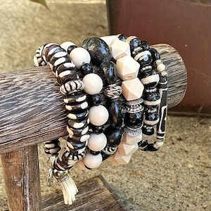 Stackable beaded, multi layered stretch bracelet in winter white and black tones.