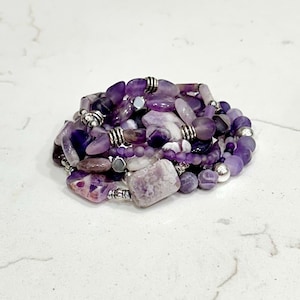 stackable beaded multilayered stretch bracelet in purple tones