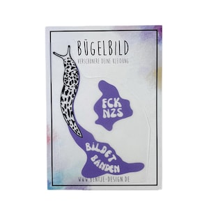 Könnte beinhalten: Bügelbild mit einem lila Schleimtier mit dem Text "Bild et Banden" und einem separaten lila Klecks mit dem Text "FCK NZS". Der Text "Bügelbild" befindet sich oben im Bild, und der Text "Verschönere deine Kleidung" befindet sich darunter.