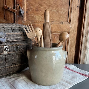 May include: A set of three ceramic mugs with a speckled, matte finish. The mugs are in shades of cream, light gray, and dark gray. Each mug has a simple, minimalist design, perfect for coffee or tea.