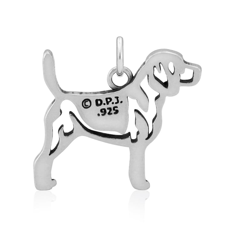 May include: Sterling silver charm of a Beagle dog, with a cutout design. The back of the charm is stamped with "D.P.J. .925".