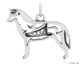 May include: Sterling silver pendant featuring a detailed silhouette of a husky dog with a canoe design inside the silhouette.