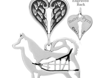 May include: Sterling silver pendant featuring a dog silhouette with a heart-shaped charm with angel wings. The back of the heart charm is engraved with the names "Shelby" and "Pyro" and the number "925".