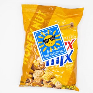 May include: A bag of Honey Nut Chex Mix snack mix with a blue and yellow sun-shaped tag that says "It's time to Chex Out for Summer. Thanks for a great year!"