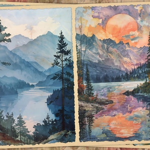 May include: Two watercolor paintings depicting a mountain lake scene. The first painting shows a lake surrounded by mountains with a blue sky and clouds. The second painting shows a lake with a large orange sun setting behind the mountains.